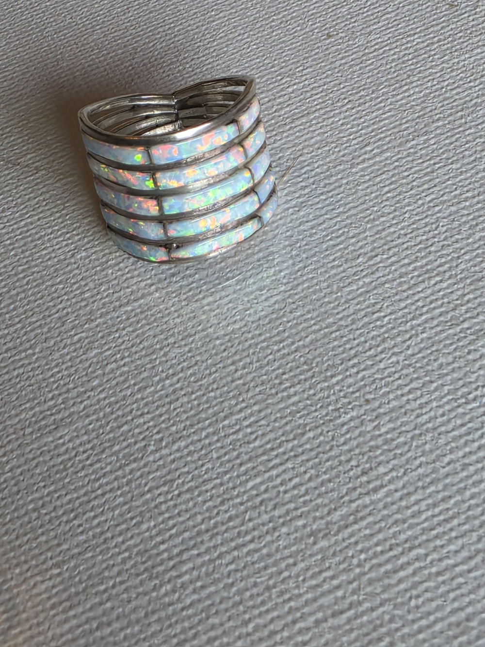 Elegant multi-row ring featuring shimmering white opal inlay. Size 6
